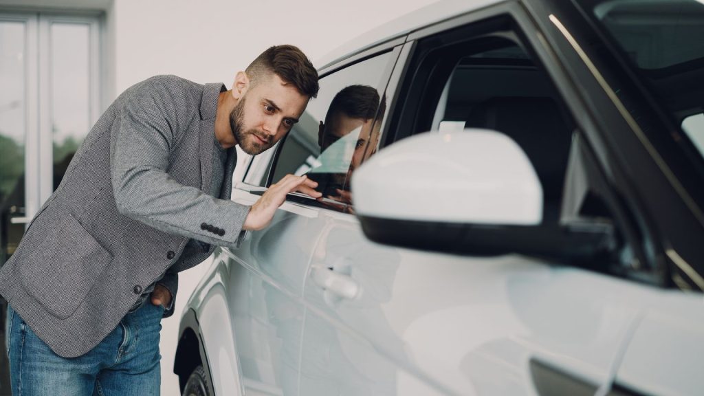 Inspector examining a late-model used car in China before export shipment
