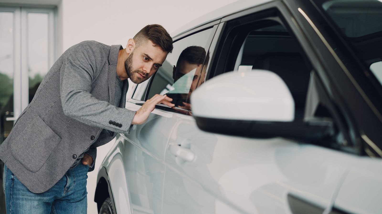 Inspector examining a late-model used car in China before export shipment